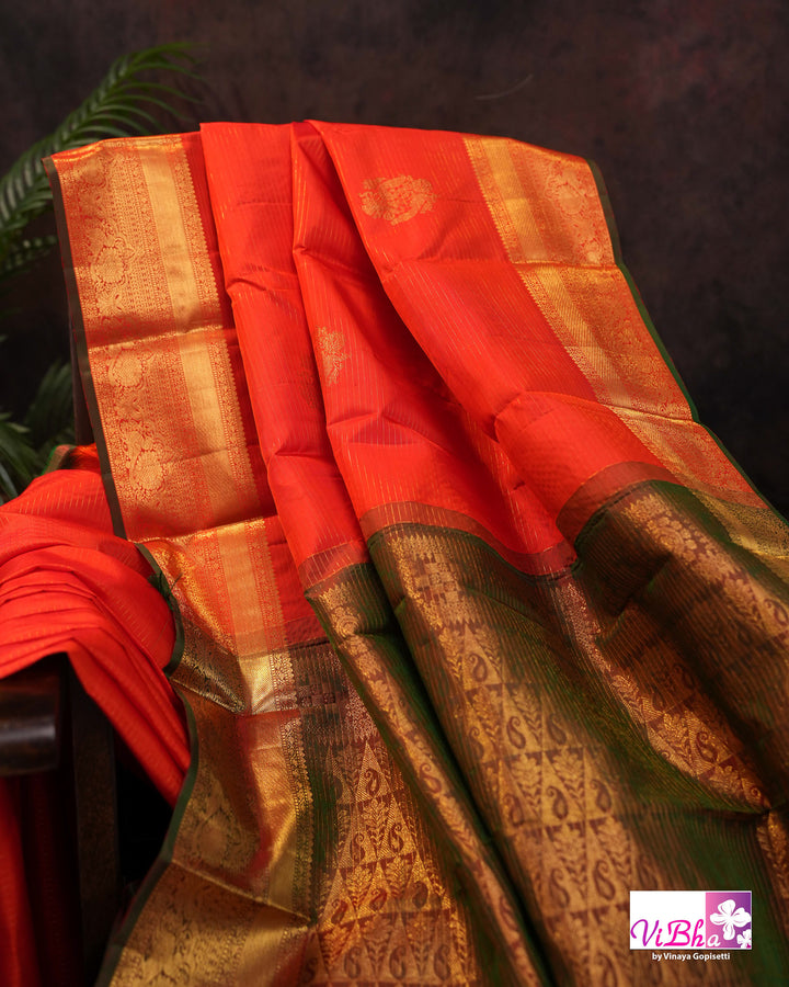 Vermilion Orange Kanchi Silk Saree with Gold Zari Weaving and Green Embroidered Blouse