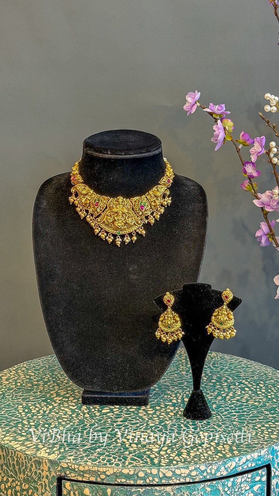 Gold Finish Lakshmi Temple Choker Set with Red and Green Stones